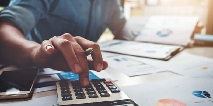 Man Calculating the Load Payment in Office